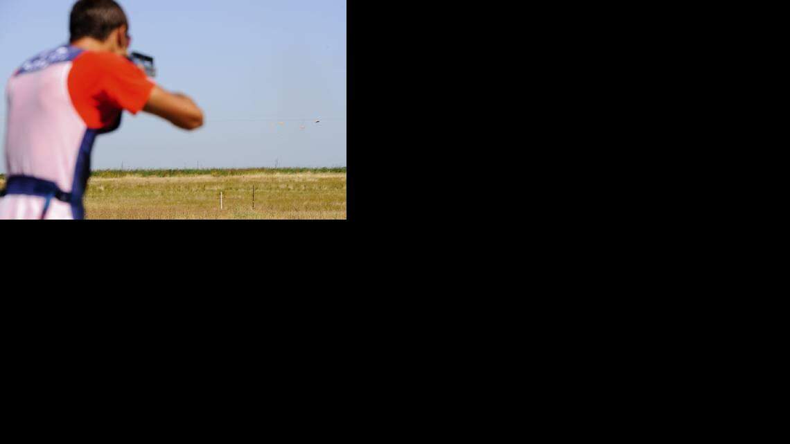 Elk Grove teen Michael Flores, is a trap shooter who is trying to make the Olympic team, shoots and hits the clay pigeon during his practice shooting at the Coon Creek Trap & Skeet Club August 15, 2011 in Lincoln, Calif.