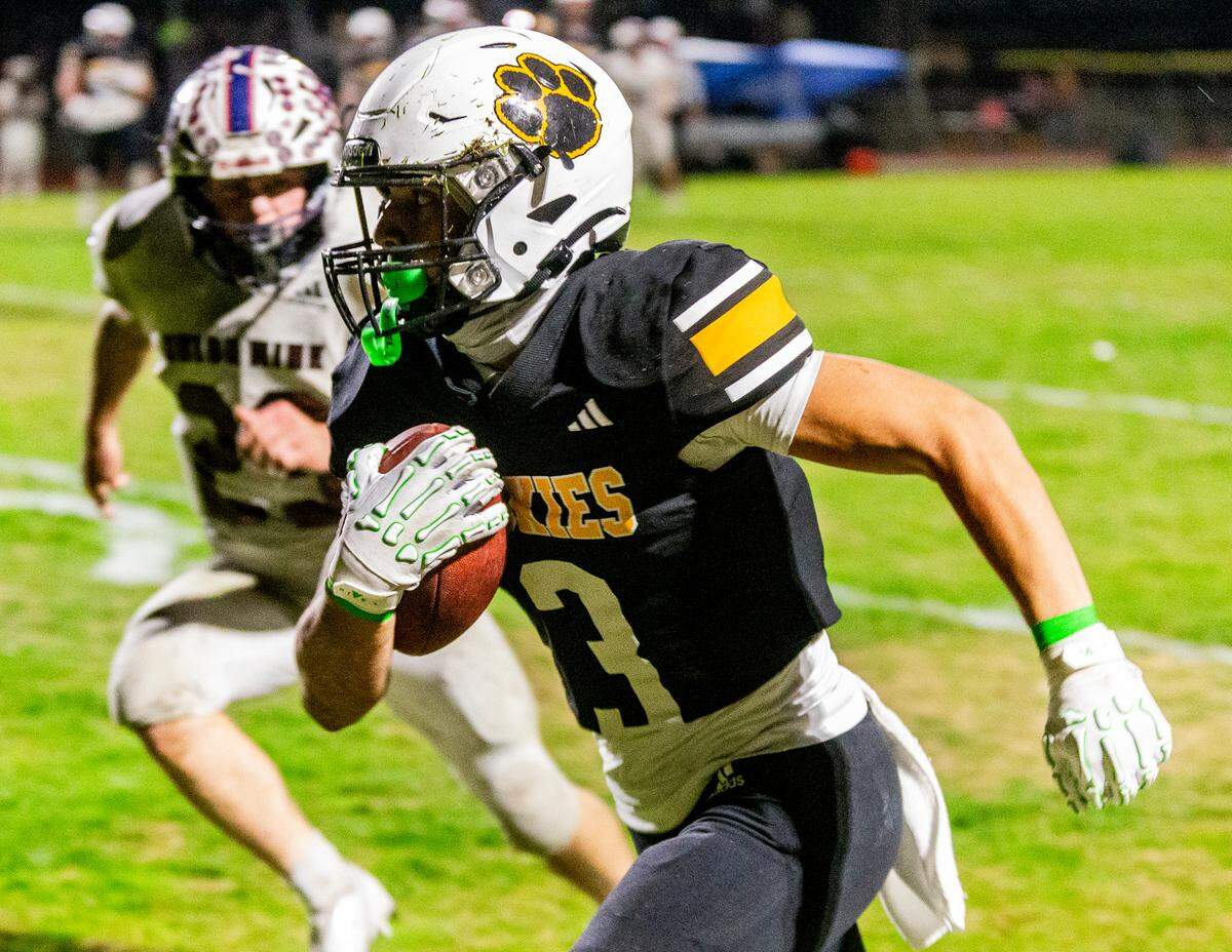Lawson Aviles, 3, of Hughson High runs upfield during the Sac-Joaquin Section Division V Semifinals against Union Mine on at Hughson High School on Friday, Nov. 22, 2024.