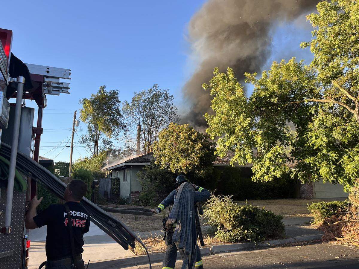 Firefighters work to put out a blaze at a vacant Modesto home on Tuesday, July 29, 2025.