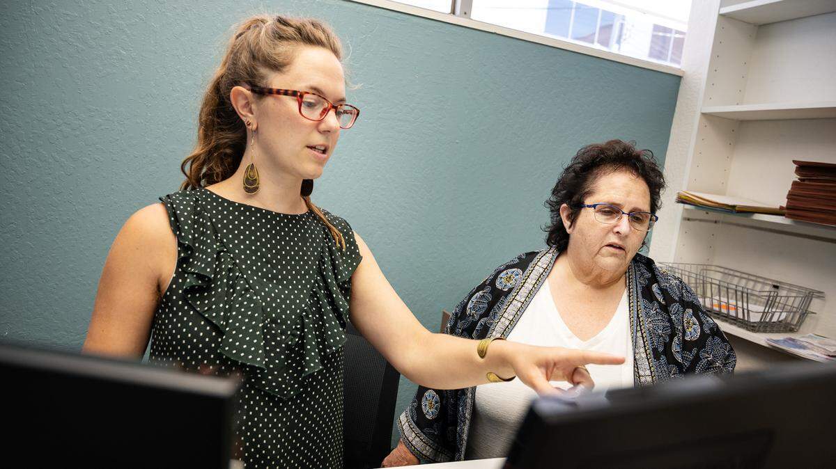 Senior Advocacy Network executive director Joyce Gandelman, right, and housing program coordinator Hannah Bradley look at client files in Modesto, Calif., on Monday, June 28, 2021. The non-profit helps low-income seniors or those facing eviction find housing.