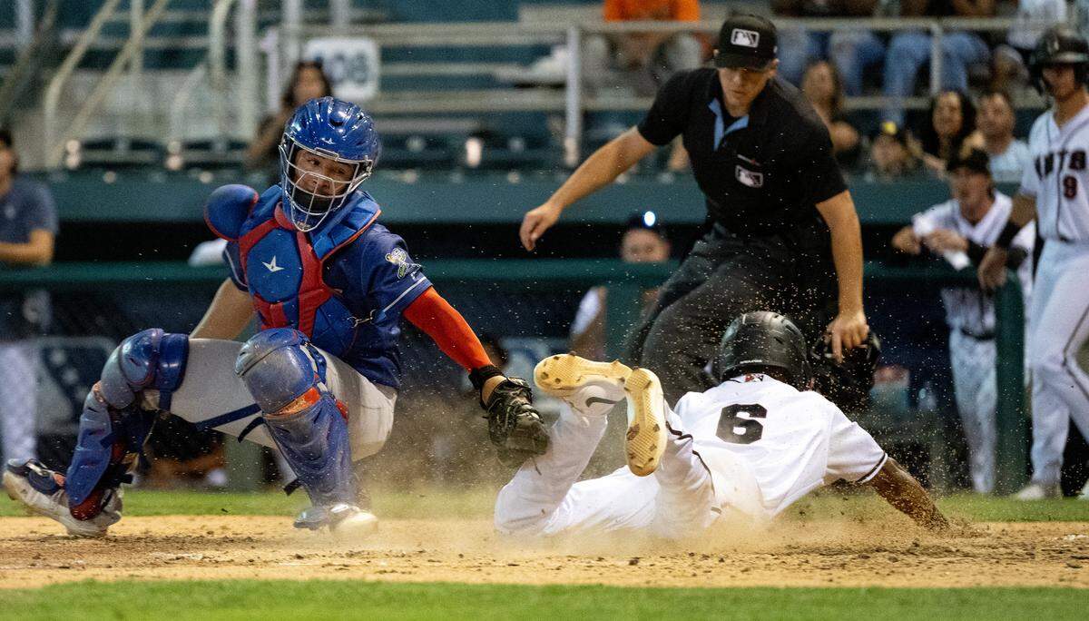 Modesto Nuts’ Curtis Washington Jr. beats the tag from Stockton’s Carlos Amaya at John Thurman Field in Modesto, Calif., Friday, July 19, 2024. Stockton won the game 8-4.