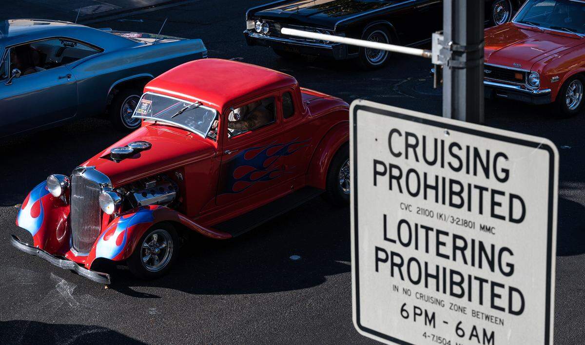 Classic car owners cruise down J Street during the “American Graffiti” car parade in Modesto, Calif., on Friday, June 10, 2022.