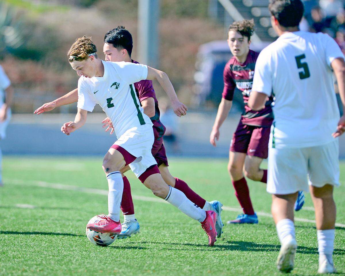 Pitman’s Zach Looney (2) breaks free from Woodcreek defenders during the Sac-Joaquin Section Division II championship against Woodcreek High School at Cosumnes River College in Sacramento, Calif. on Saturday, March 1, 2025.