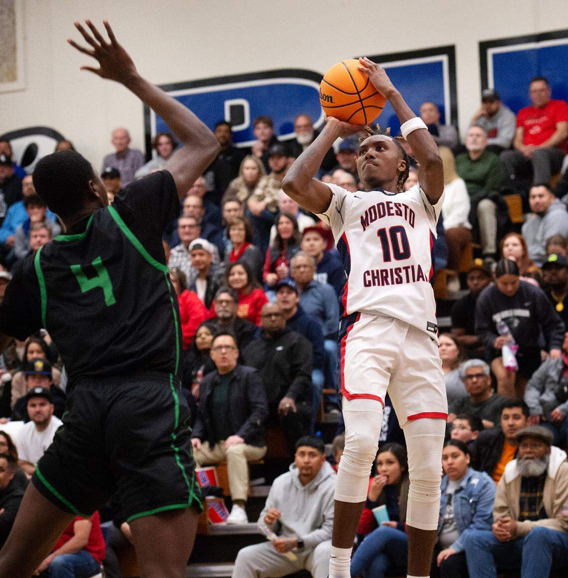 Modesto Christian’s BJ Davis shoots over St. Joseph’s Abdoul Bare in the NorCal Open Division championship game at Modesto Junior College in Modesto, Calif., Tuesday, March 7, 2023. St. Joseph won the game 72-58.