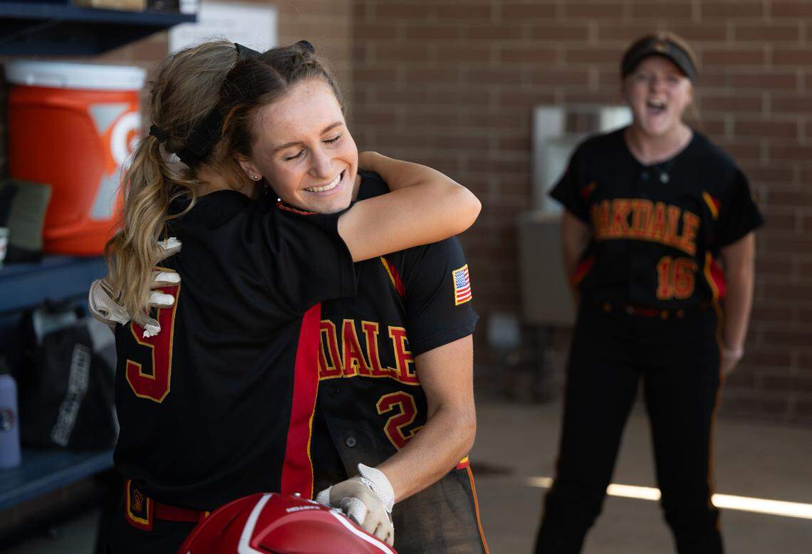 Oakdale’s Morgan Wright gets a hug from teammate Reese Donaldson during the Sac-Joaquin Section D III softball championship game with Capital Christian at Cosumnes River College in Sacramento, Calif., Saturday, May 25, 2024. Wright led off the inning with a double and scored the first run of the game.