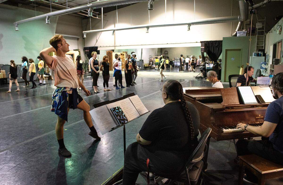 Modesto Performing Arts actor Grant Landon, left, rehearses a musical number during rehearsal of “A Chorus Line” in Modesto, Calif., on Thursday, May 26, 2022.