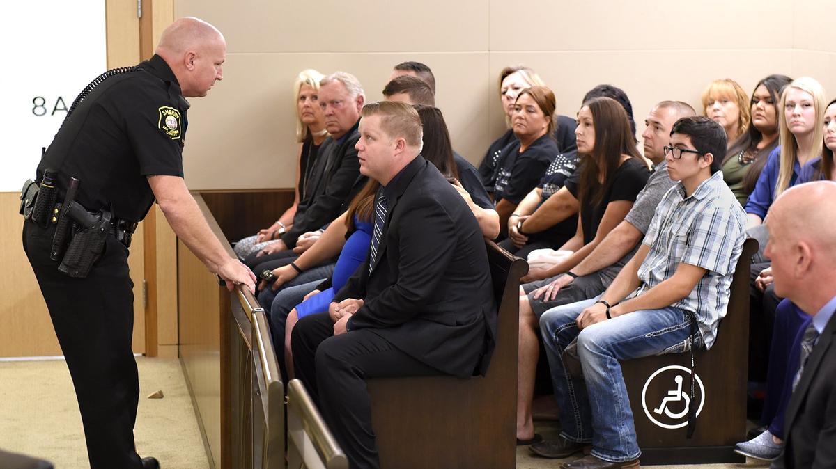 Stanislaus County Sheriff’s Deputy Justin Wall (center) receives instructions from a court bailiff about leaving the courtroom on Monday July 30, 2018 in San Joaquin County Superior Court during a hearing.