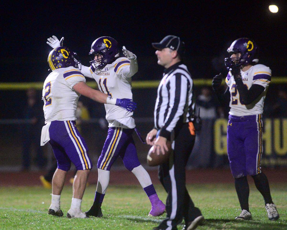 Orestimba receiver Vince Lopez (11) celebrates with teammate Juan Esquivez (2) after scoring a touchdown during a Sac-Joaquin Section Division VI playoff game against Hughson in Hughson, California, on Nov. 18, 2022. Hughson won 21-17.