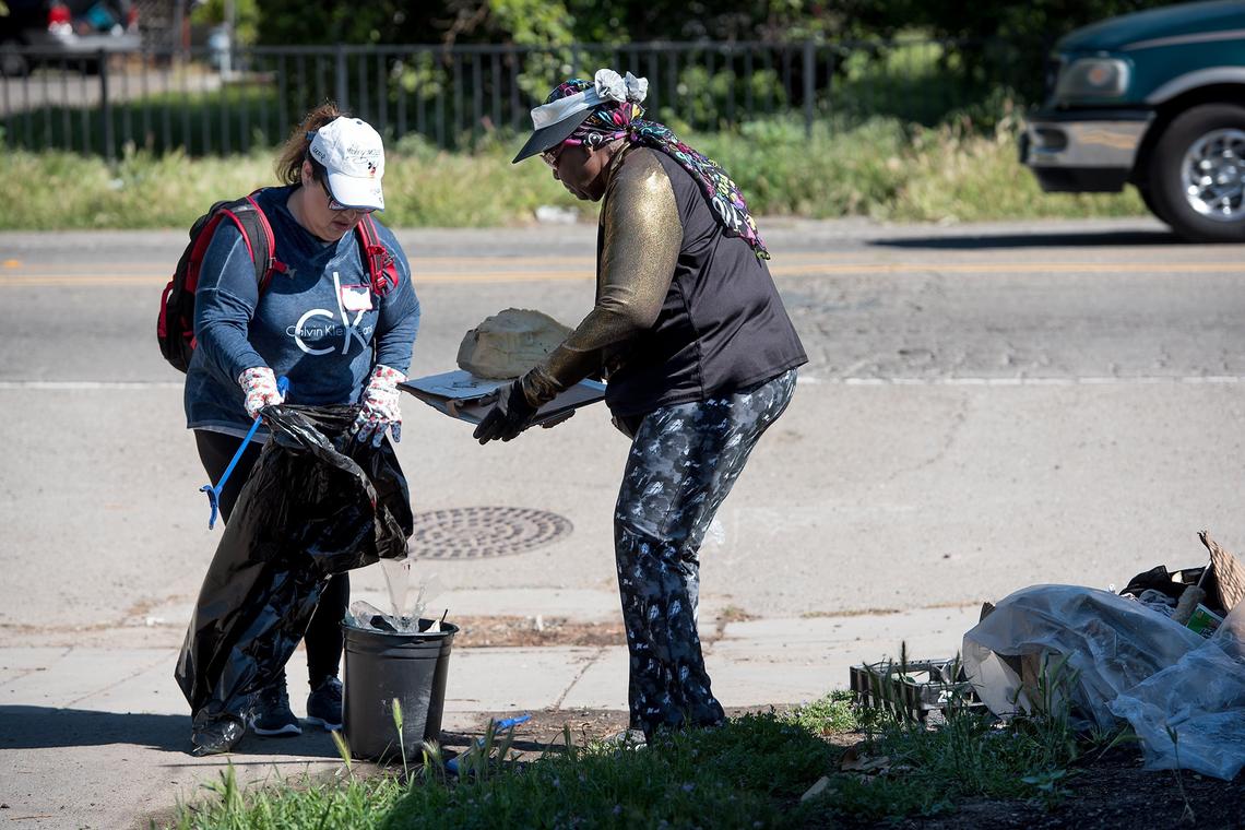 Gladys Williams, right, and Rocio Oseguera pick up trash at the entrance of the Helen White Memorial Trail during Love Modesto, a communitywide volunteer day on April 21, 2018.