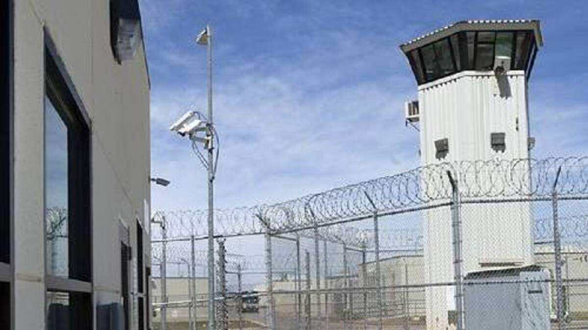 A guard tower, above left, at Calipatria State Prison in Imperial County rises adjacent to an electric fence. March 30, 2010.