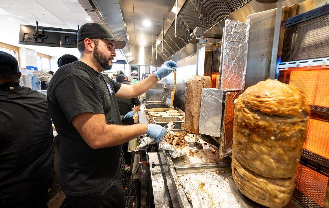 Nick Tsigaris helps out during the grand opening of Nick the Greek restaurant in Riverbank, Calif., Tuesday, September 12, 2023.