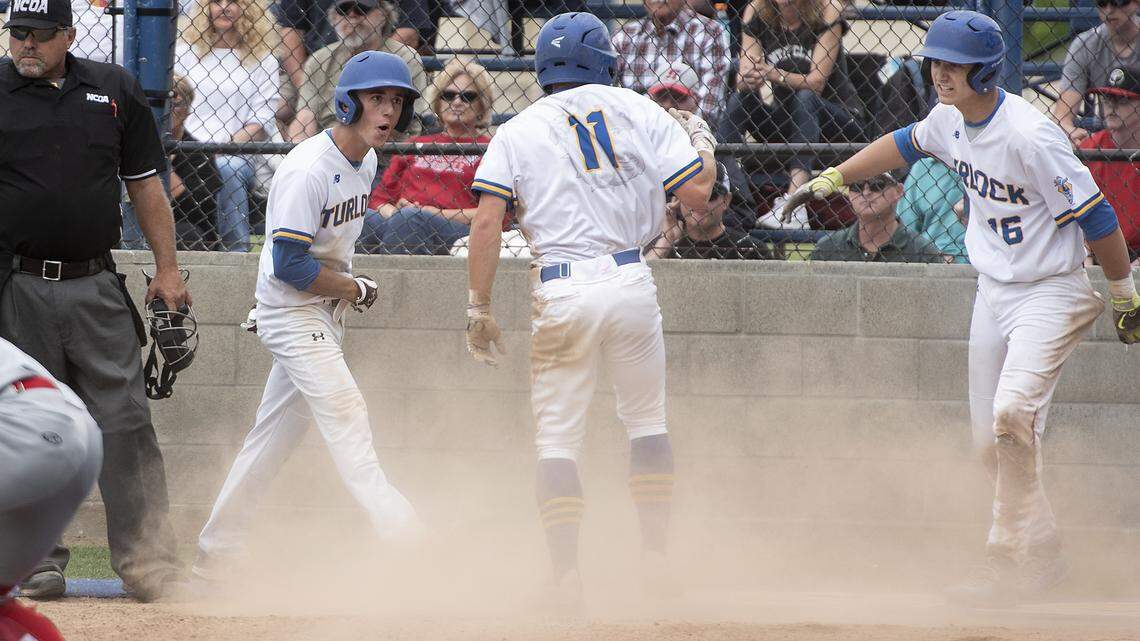 Turlock’s Tyler Soderstrom (16) greets Dalton Linn and Mason King (11) as they cross home plate during the Sac-Joaquin Section baseball playoff game with Lincoln at Turlock High School in Turlock, Calif., Tuesday, May 14, 2019.