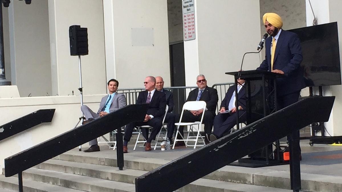 Mani Grewal, chairman of the county Board of Supervisors, speaks at the Modesto Library on Thursday, flanked by fellow supervisors. (Ken Carlson/ The Modesto Bee)