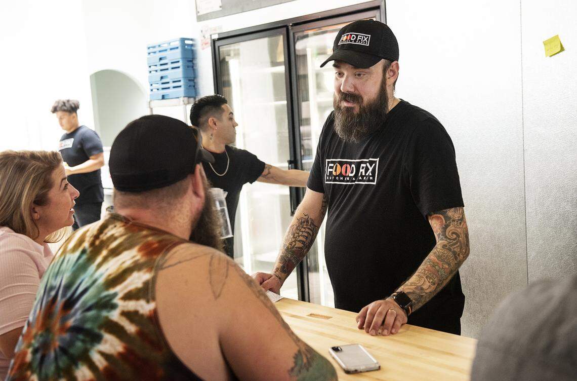 Owner Hank Olson talks with customers at Food Fix Butcher & Baker restaurant in Modesto, Calif., on Thursday, Aug. 22, 2019. 