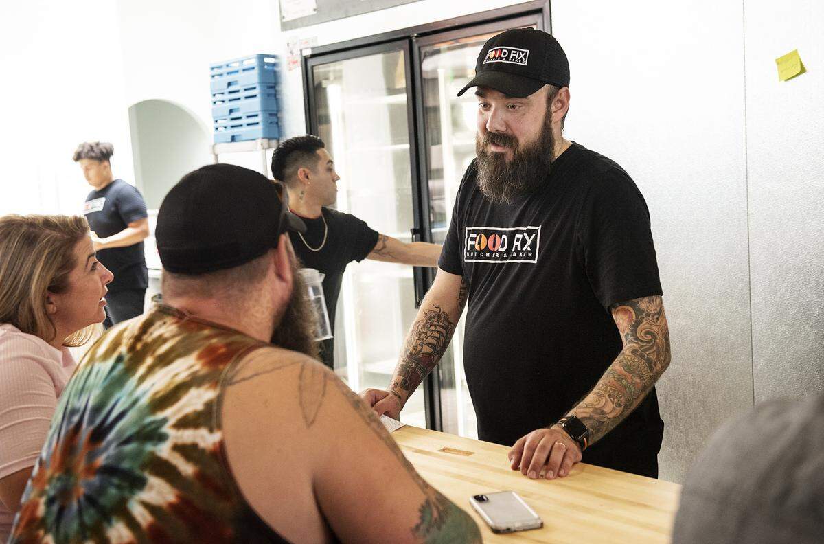 Owner Hank Olson talks with customers at Food Fix Butcher & Baker restaurant in Modesto, Calif., Thursday, Aug. 22, 2019.