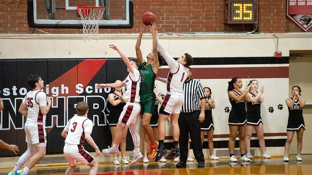 Pitman’s Cole Martin (2), Modesto’s Jaden Johnson (1) and Andrew Poulsen battle for a rebound during a Central California Athletic League game at Modesto High School in Modesto, Calif., Friday, Jan. 13, 2023. Pitman won the game 70-46.