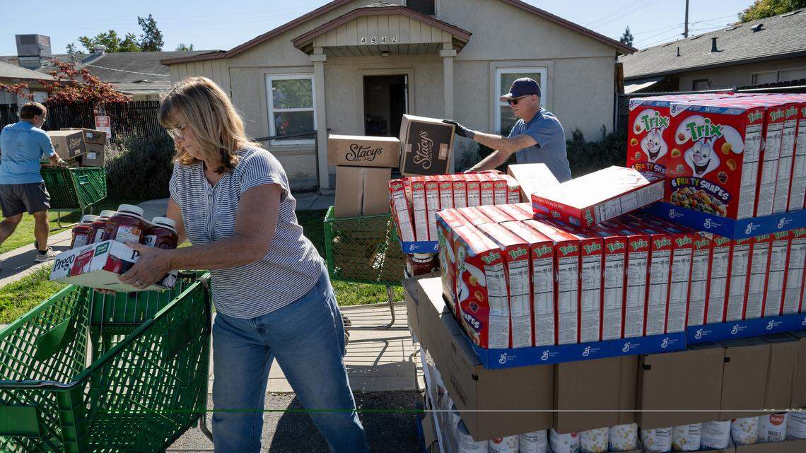 Salida Food Bank director Kim Brown unloads a shipment of donated food products with volunteers Denn Wesson, right, and John Kidroske, left, at the Salida Food Bank in Salida, Tuesday, Oct. 28, 2025.
