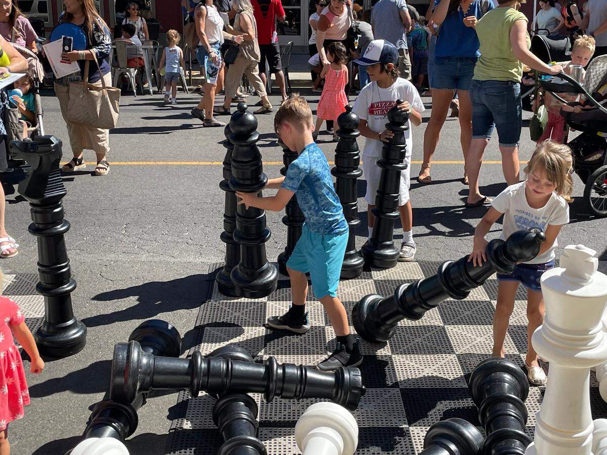 Possible future chess masters get a feel for the game at the Modesto Children’s Museum’s Launch the Adventure street festival on 11th Street downtown on Saturday, Aug. 13, 2022.