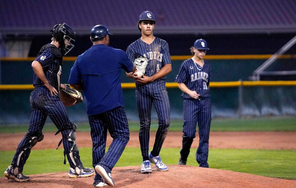 Central Catholic coach Danny Ayala meets with relief pitcher Marcus Davenport for a pitching change during the Sac-Joaquin Section D-III championship game with Yuba City at Sacramento City College on Wednesday, May 21, 2025.