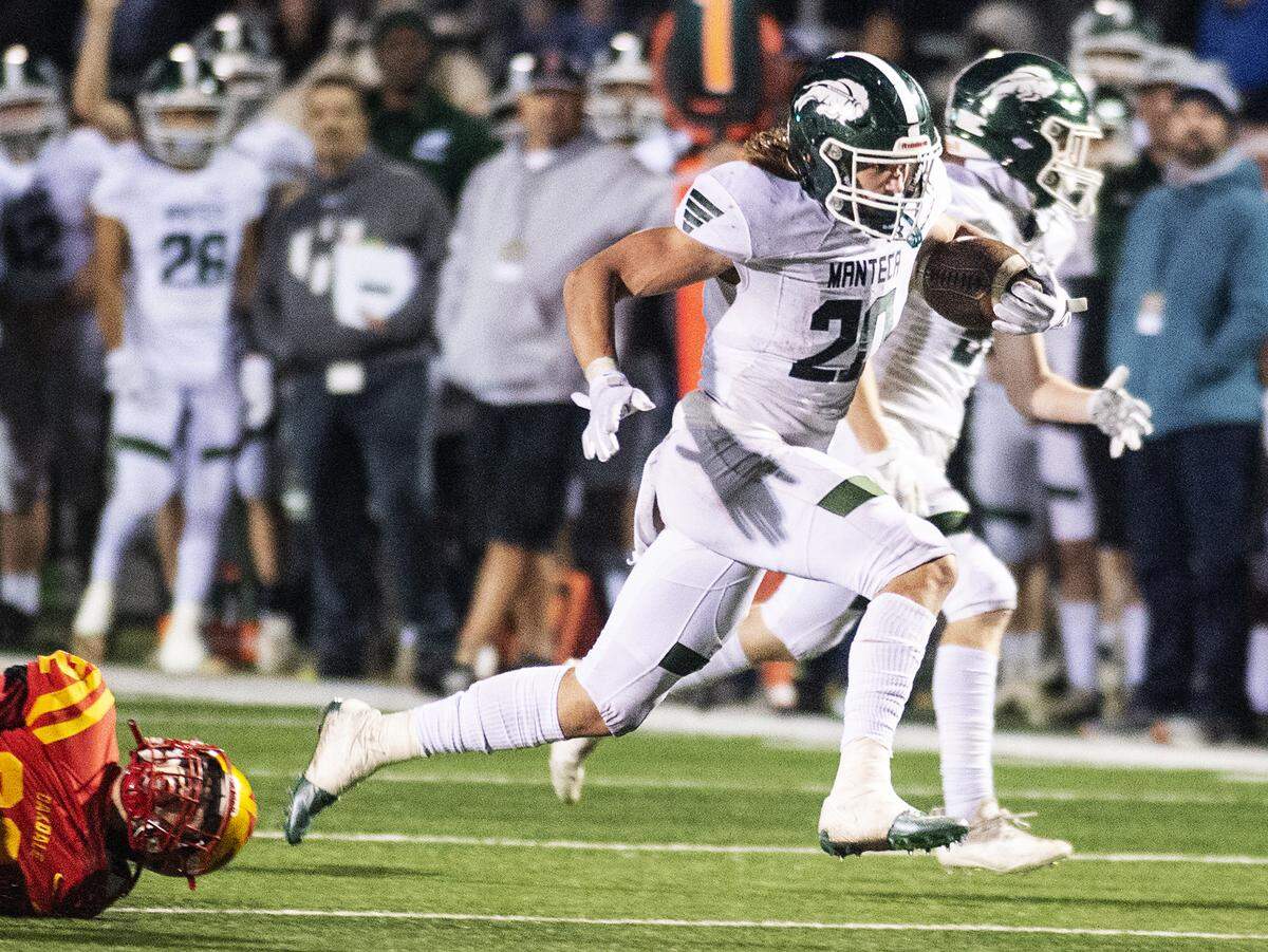 Manteca’s Blake Nichelson runs for a touchdown during the Sac-Joaquin Section Division III championship game with Oakdale at St. Mary’s High School in Stockton, Calif., on Friday, Nov. 25, 2021. Manteca won the game 35-28.