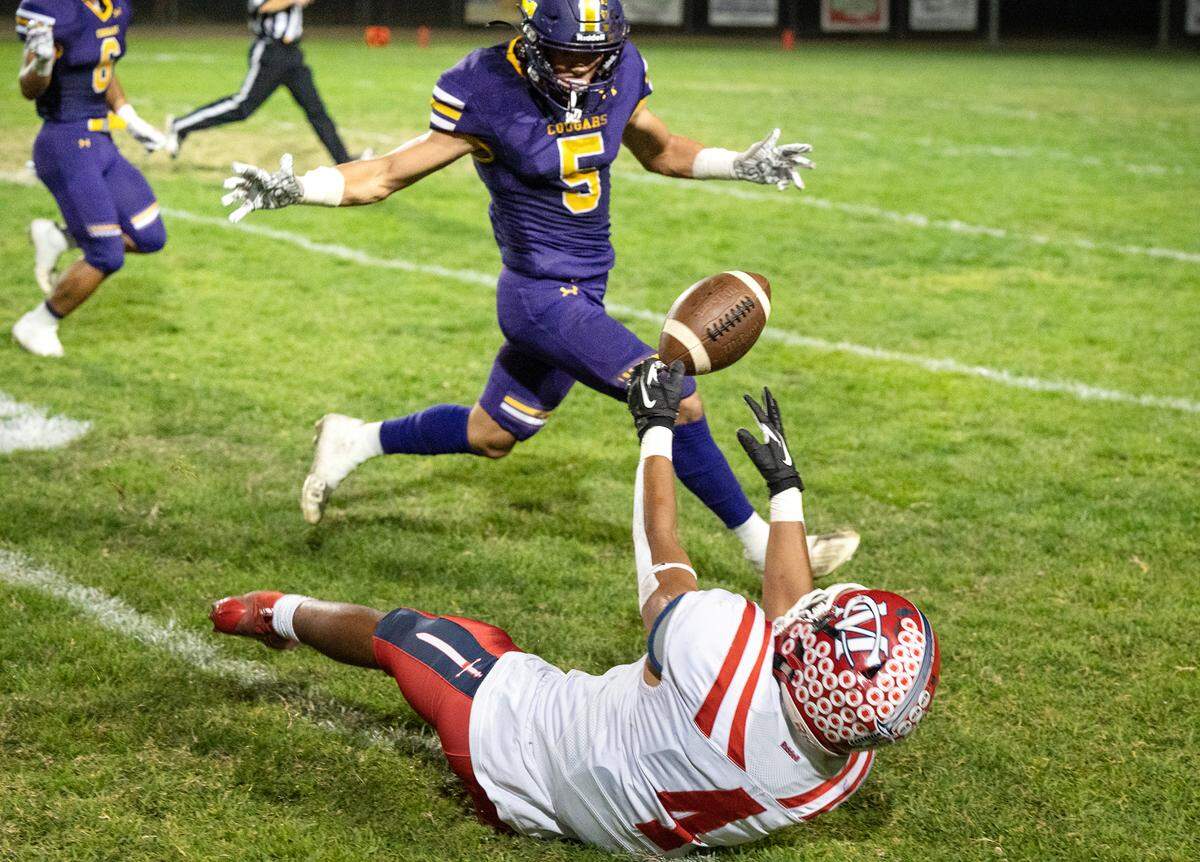 Modesto Christian’s Raymond Corral Jr. tries to catch a wild throw during the Trans-Valley League game with Escalon in Escalon, Calif., Thursday, Oct. 6, 2022. Escalon won the game 62-30.