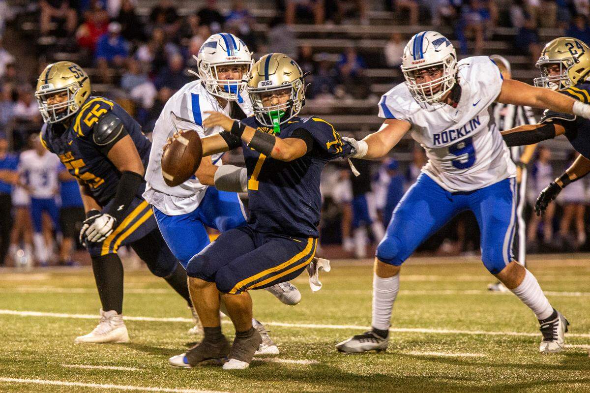 Scout Silva, 7, of Turlock High looks for an open man as Rocklin’s Chase Baker closes in during the first half of their game at Turlock High Aug. 23, 2024.