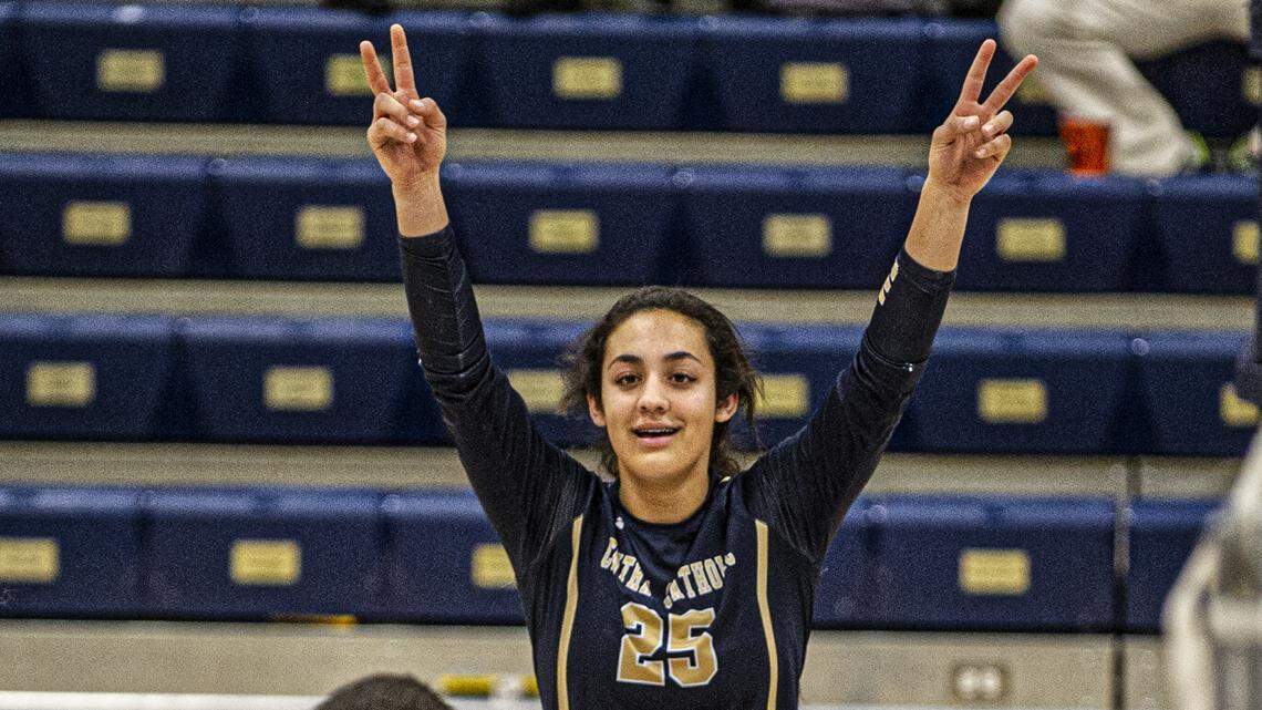 Abby Castillon raises a couple of peace signs after winning a volley, during a playoff game between Sonora and Central Catholic, in Modesto, on Thursday, October 31.