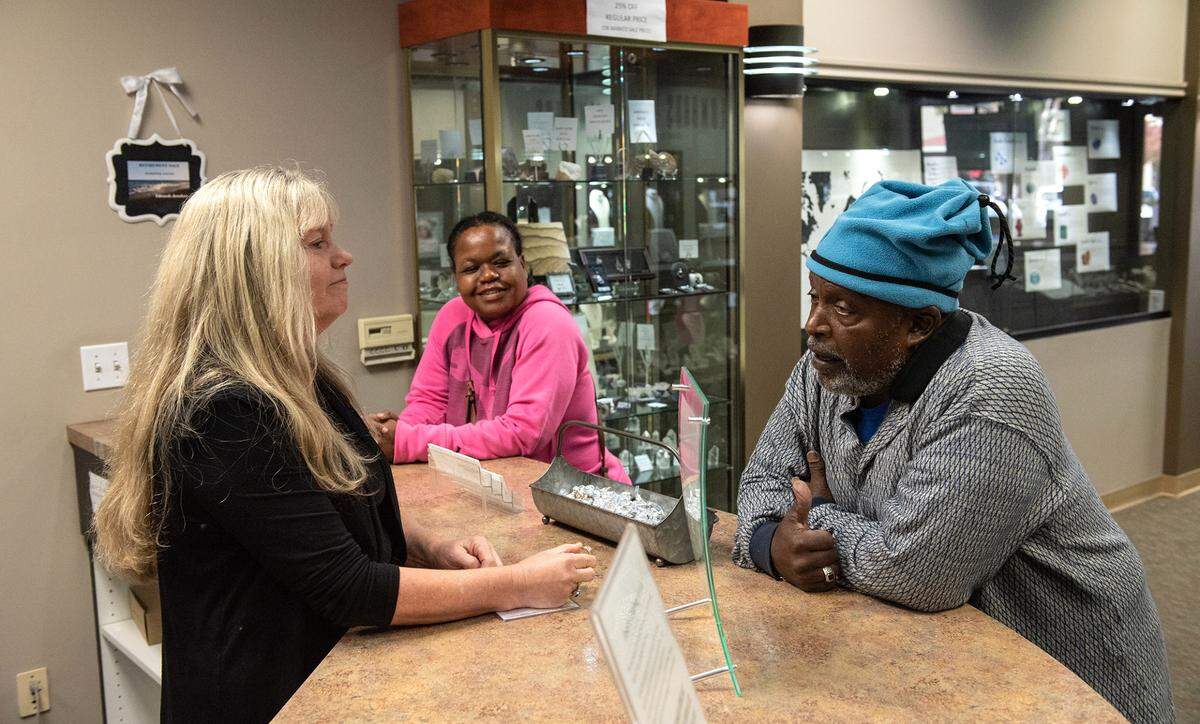 Edwards Jewelers owner Nancy Culbertson, left, talks with customers Elvin Hamilton, right, and Jackie Hamilton, middle, about ring repair work in Modesto, Calif., Wednesday, Nov. 9, 2022.