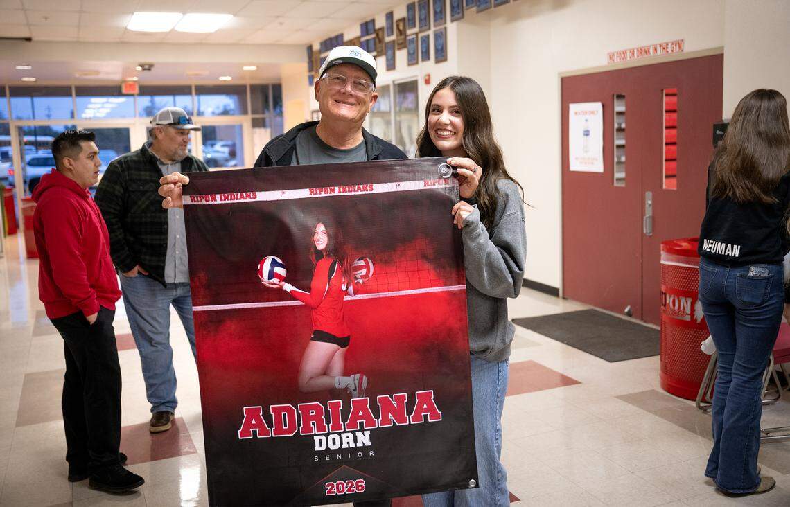Adriana Dorn with her grandfather Rick Russell during a  signing ceremony at Ripon High School in Ripon, Thursday, Nov. 13, 2025. Dorn has signed to play volleyball at the University of the Pacific in Stockton. 