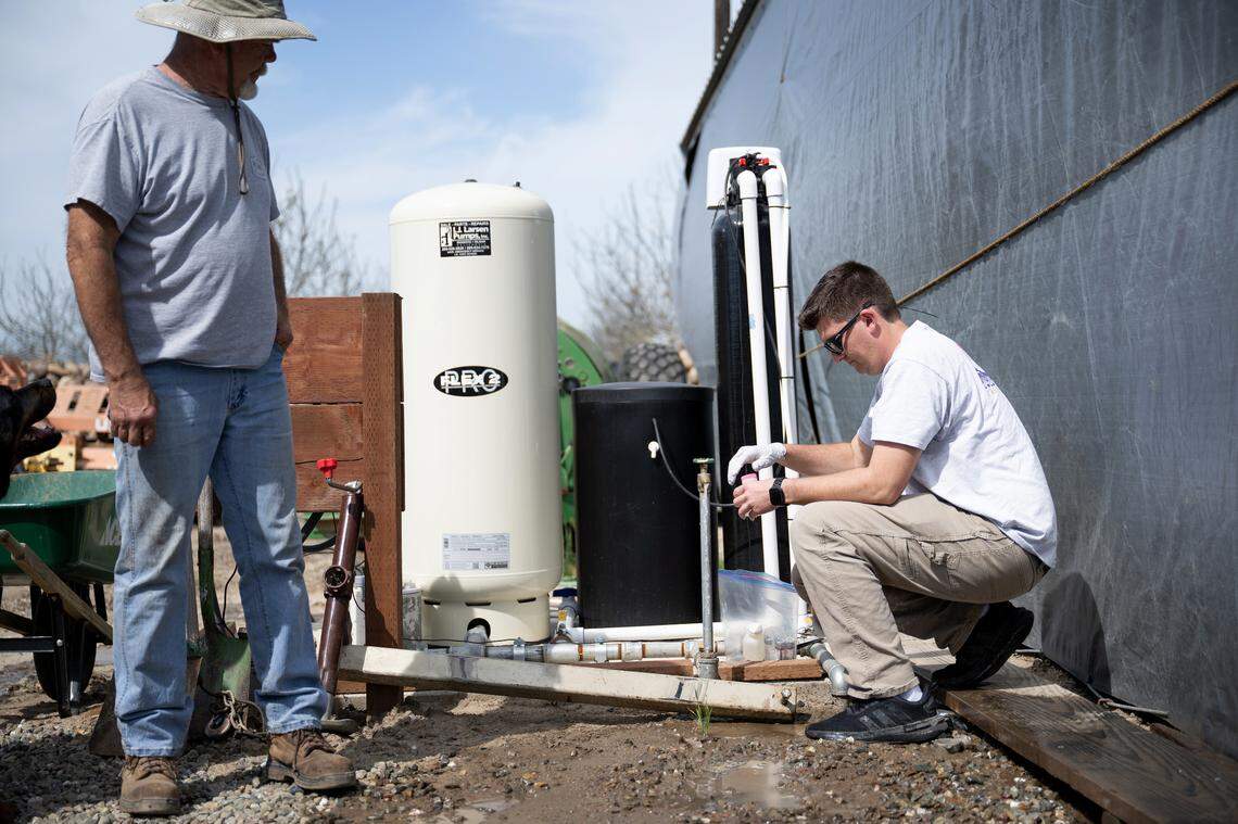 Geoanalytical Laboratories technician Logan Davis draws a water sample from the domestic well on the property of Tom Ulm in Modesto, Thursday, April 10, 2025. The non-profit Valley Water Collaborative provides free domestic well testing and clean drinking water to people in the San Joaquin valley affected by high nitrate levels.