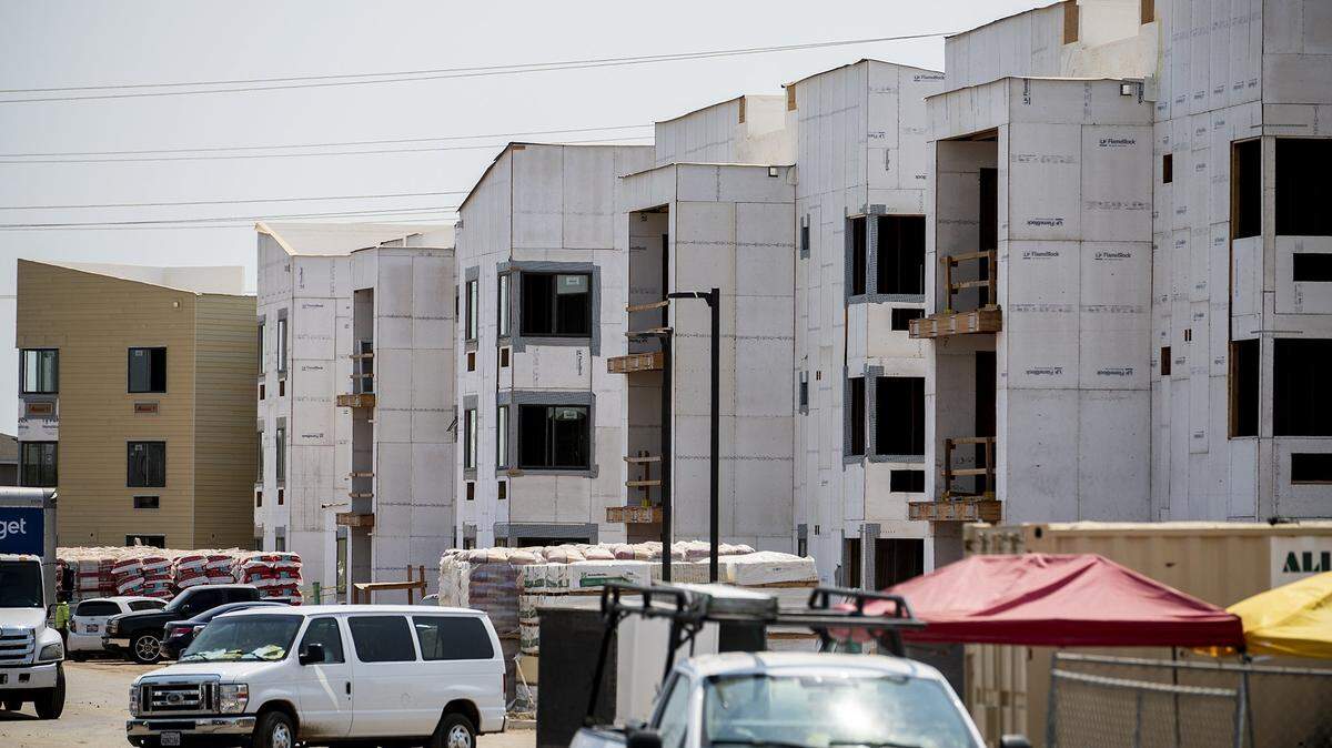 Construction crews continue work on the Merced Station apartment complex located at 2980 East Yosemite Avenue in Merced, Calif., on Thursday, Aug. 12, 2021.