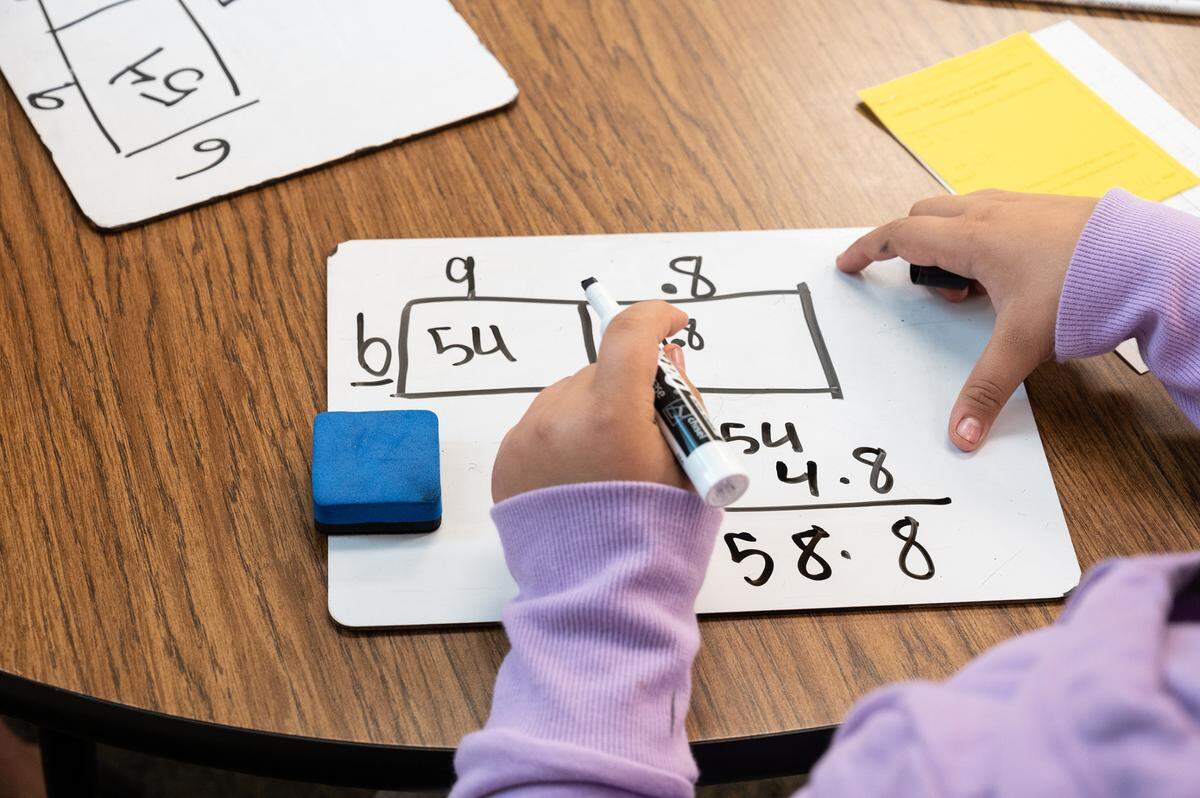 Fifth grade student Camila Caracheo works on multiplying decimals during class at Don Pedro Elementary School in Ceres, Calif., on Thursday, Nov. 4, 2021.