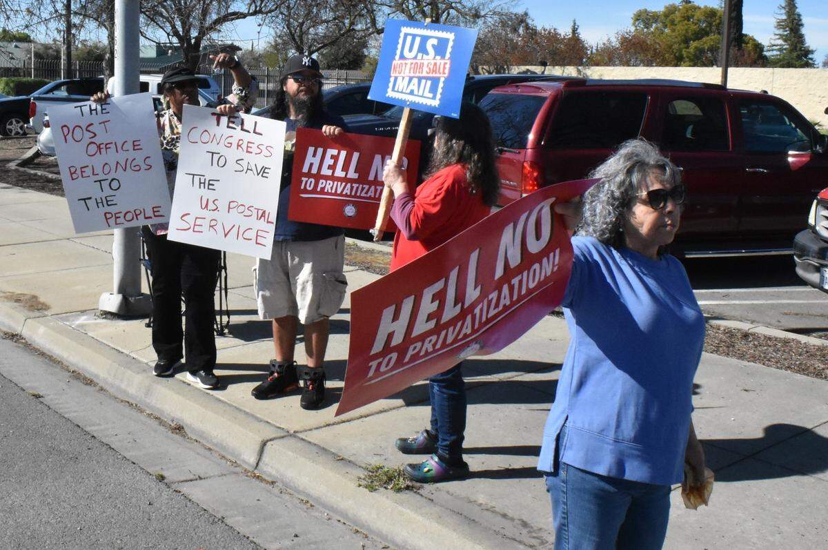 Postal workers, former postal workers and their supporters rally along Mitchell Road outside the Ceres post office on Sunday, March 23, 2025.