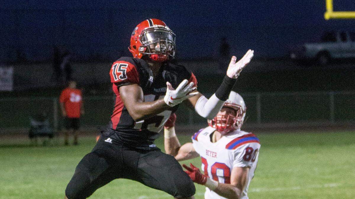 Daeveon Graves, 15, of Modesto High grabs a close pass near the 20 yard line with Beyers Alex Munden, 80, closing in. Beyer High took on Modesto High during high school football Friday Aug. 24, 2018