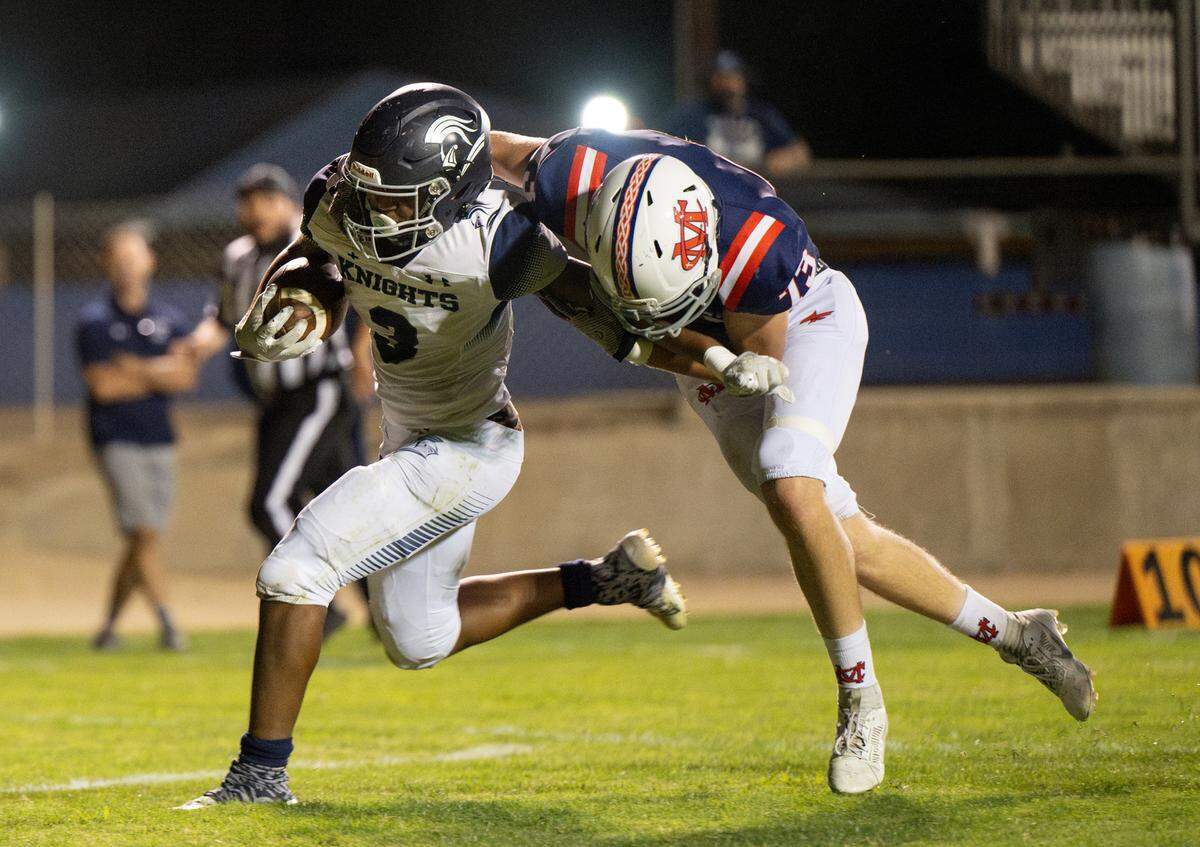Stone Ridge Christian’s Daijon O’Neil pushes past Modesto Christian’s Noah Avery for a touchdown run during the nonleague game at Modesto Christian High School in Salida, Calif., Friday, Sept. 15, 2023.