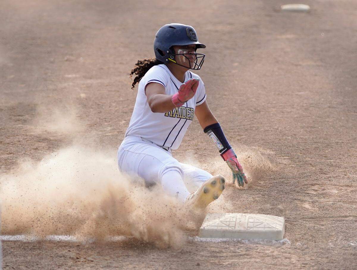 Central Catholic’s Jazmarie Roberts slides into third base after hitting a triple during a Valley Oak League game against Manteca at Manteca High School on Tuesday, April 22, 2025.