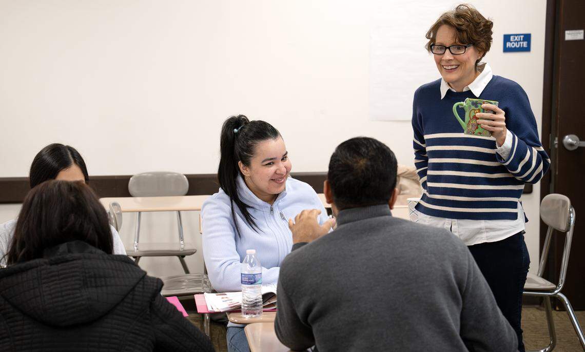 MJC professor Ruth Luman speaks with students Iman Bin, middle, and Masihullah Momand, right, during a English language class for nursing assistant students at Modesto Junior College in Modesto, Wednesday, Nov. 26, 2025. 