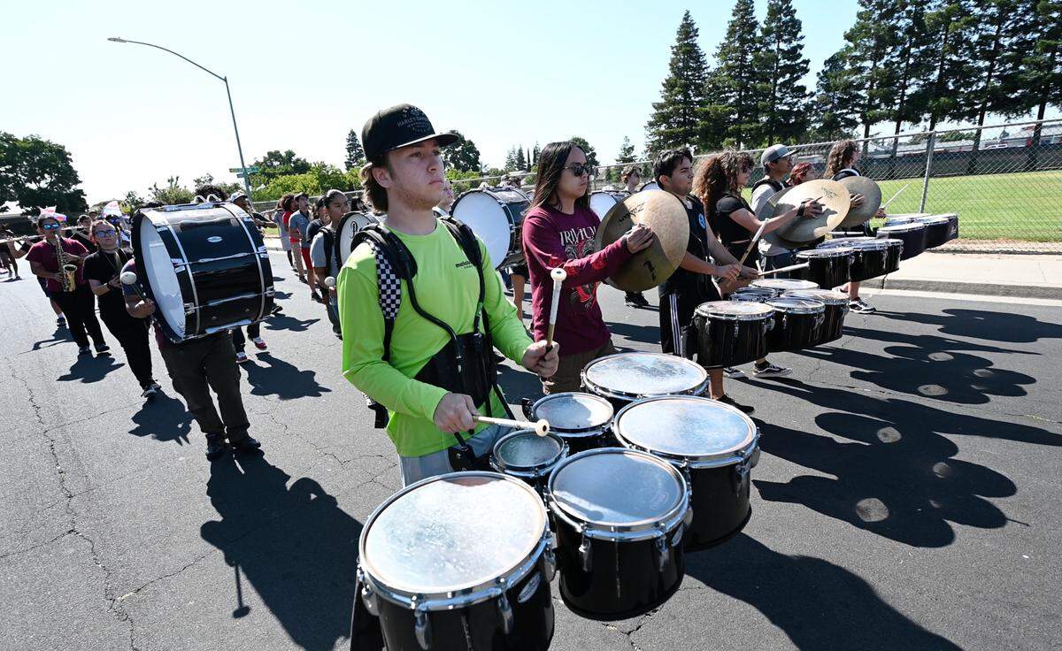 Modesto City Marching Brigade members, including Noah Muller on tenor drums, rehearse behind Beyer High School in Modesto, Calif., Wednesday June 28, 2023. 130 students from seven Modesto City High schools form the band, which is headed to Washington D.C to perform in the Independence Day parade.