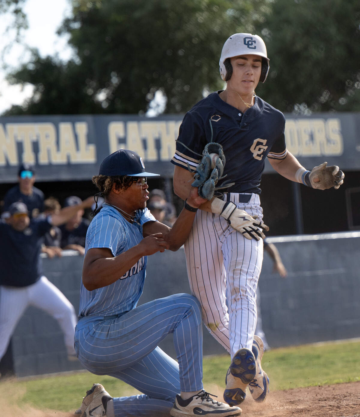Central Catholic’s Chase Perino scores as the ball is knocked out of Oakmont’s Jaylan Patterson glove during the DIII Sac-Joaquin Section semifinal playoff game with Oakmont at Central Catholic High School in Modesto, Wednesday, May 14, 2025.
