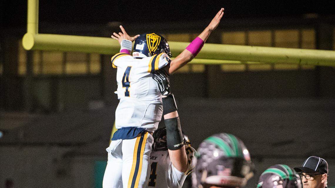 Turlock’s Everett Johnson lifts up quarterback Jonah Kosakiewicz as they celebrate a touchdown during the Central California Athletic League game with Pitman at Turlock High School in Turlock, Ca., on Friday, Oct. 26, 2018. 