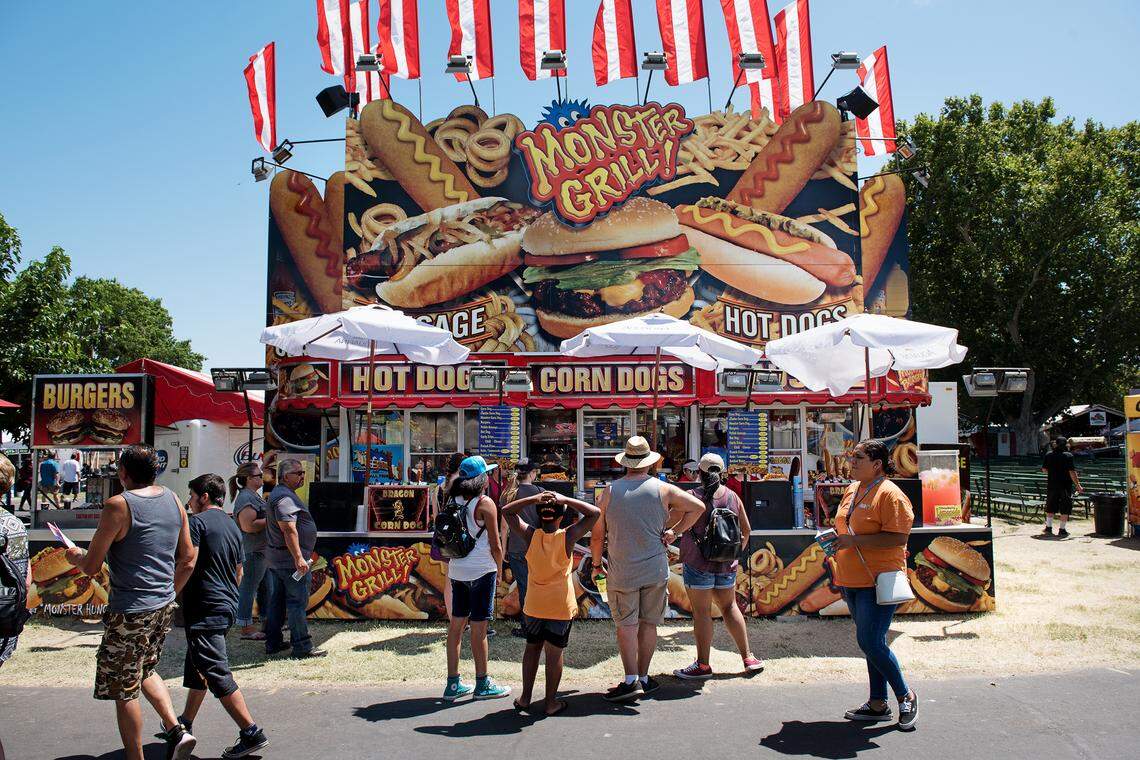 People wait to order food at the Stanislaus County Fair in Turlock, Calif., Friday, July 14, 2018. 