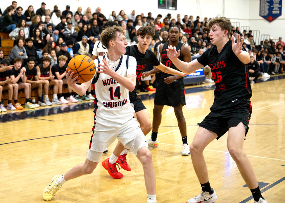 Modesto Christian’s Elijah Payne looks to pass the ball during the Holiday Hoop Classic championship game with Buchanan at Modesto Christian High School in Salida, Monday, Dec. 30, 2024.
