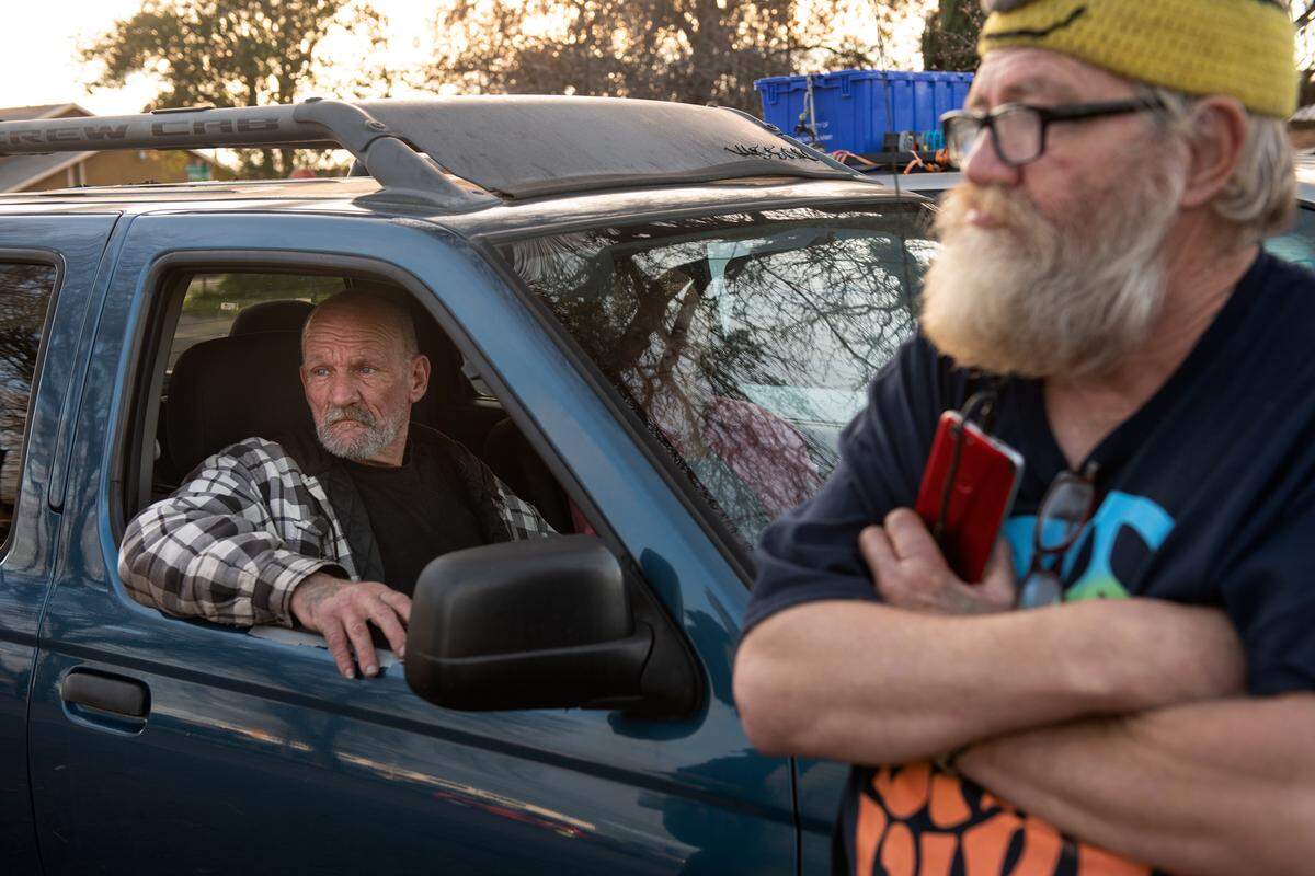 Frank Yrigoyen, left, and Dan Allen, right, both live in their cars and are hoping to find a rental house in Modesto, Calif., on Wednesday, Jan. 5, 2022.