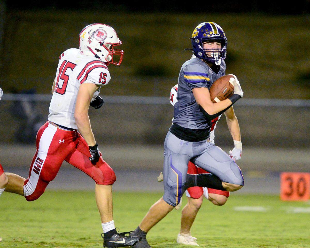 Escalon receiver Sam Jimenez races past a Ripon defender during a game between Escalon High School and Ripon High School in Escalon, California on October 20, 2023. 