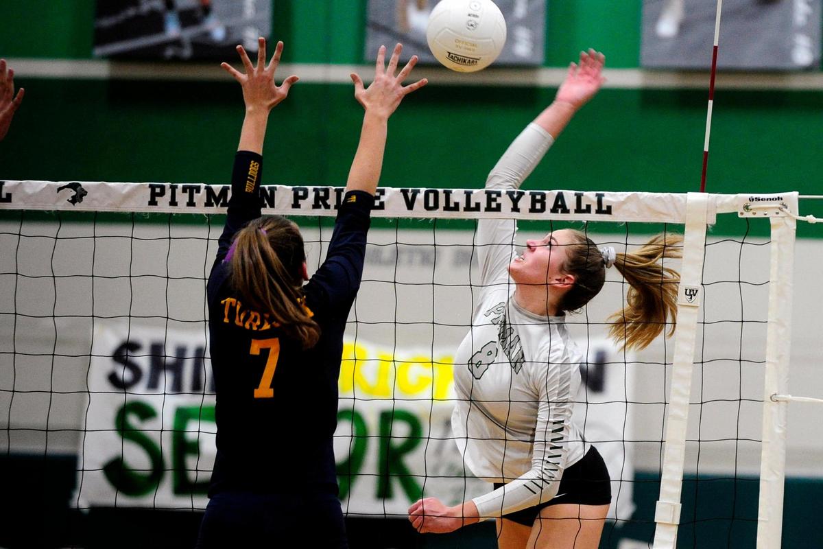 Turlock’s Mary Padilla (7) goes to block as Pitman’s Emily Vander Weide (8) spikes the ball, during the senior night, crosstown volleyball matchup of Turlock High at Pitman High, on Monday, Oct., 15 in Turlock, California.