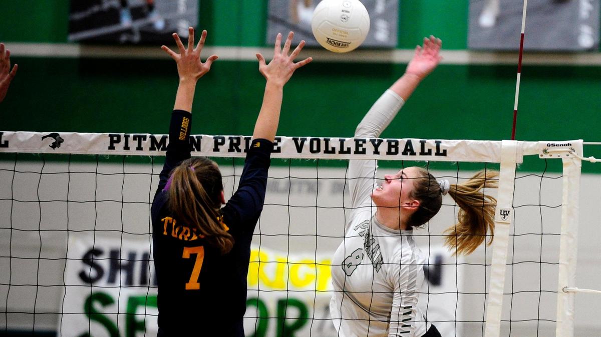 Turlock’s Mary Padilla (7) goes to block as Pitman’s Emily Vander Weide (8) spikes the ball, during the senior night, crosstown volleyball matchup of Turlock High at Pitman High, on Monday, Oct., 15 in Turlock, California.