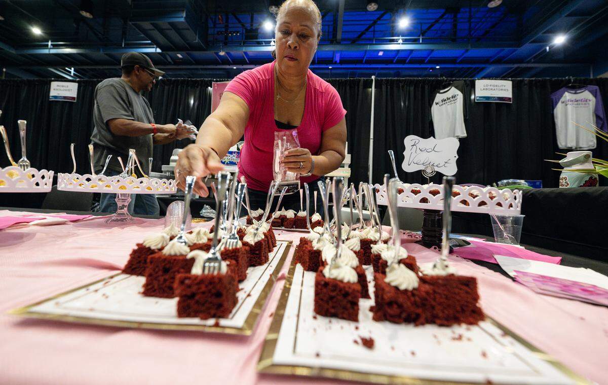 Donna Brown from D. Renees Pound Cakes & Slushies preps cake samples during Edible Extravaganza fundraising event for the Center for Human Services in Modesto, Calif., Thursday, Oct. 5, 2023.