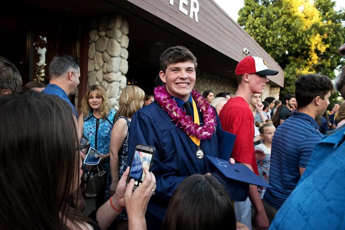Brandon Martin is all smiles as he greets family after the Big Valley Christian School graduation ceremony at Big Valley Grace Community Church in Modesto, Calif., Friday, June 1, 2018. Martin is joining the Navy.