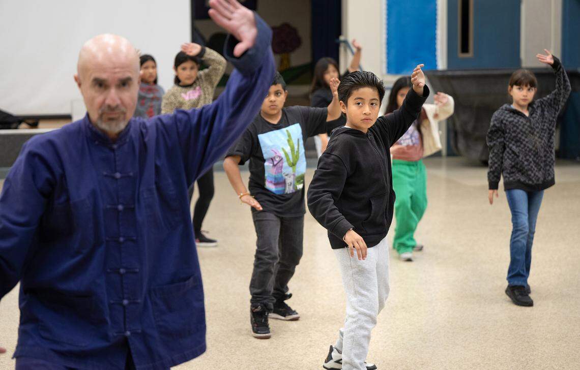 Tai chi instructor Naser Ataee leads a class of students including Angel Rangel, middle, at Orville Wright Elementary School in Modesto on Thursday, March, 13, 2025.