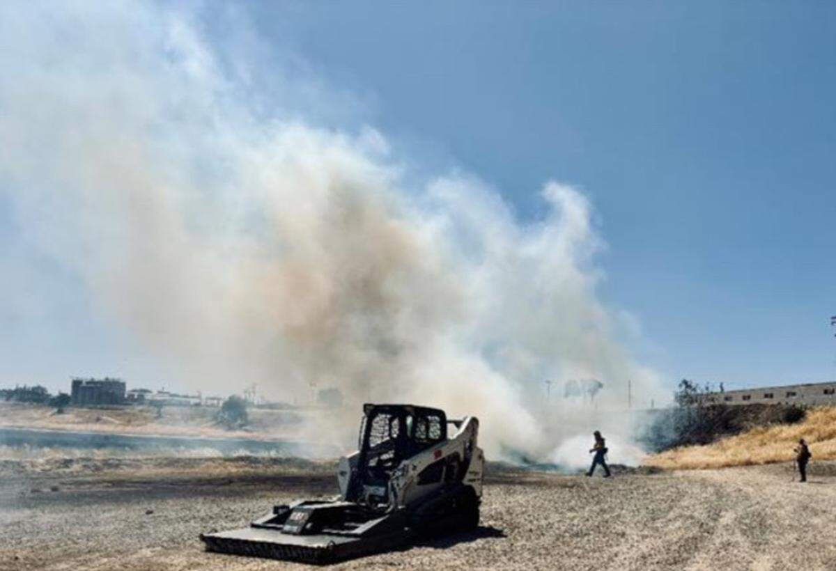 Vegetation fire between 9th and 7th Streets on Thursday.